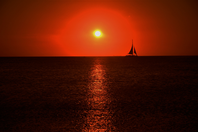 Aruba Wall Art Photography of a sunset with a sailboat in Palm Beach, Aruba. Aruba Sunsets.